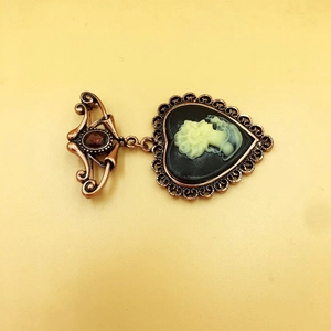 Vintage bronze heart cameo brooch with a lady portrait and red gemstone accent