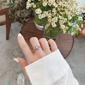 Close-up of rose gold heart ring with micro-pave crystals worn on a hand