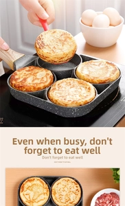 Close-up of four-hole non-stick maifan stone pan frying four eggs at once with a spatula