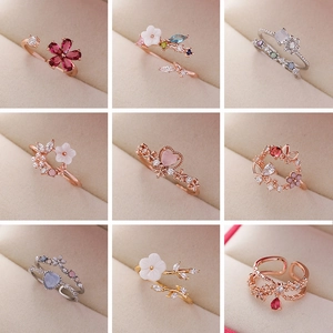 Assortment of crystal flower and heart rings in rose gold, silver, and gold finishes
