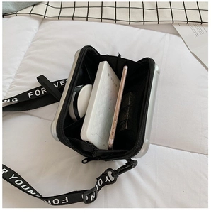 Internal view of silver hard shell mini suitcase bag showing mesh pockets for mobile phone