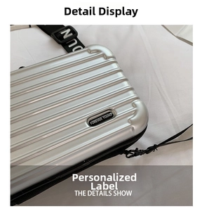 Detail of silver hardshell mini bag with horizontal stripes and Forever Young logo