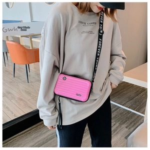 Pink mini hardshell suitcase crossbody bag with Forever Young printed strap detail