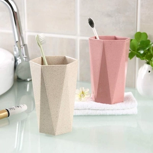 Eco-friendly geometric diamond shape mouthwash cups in beige and pink for bathroom use