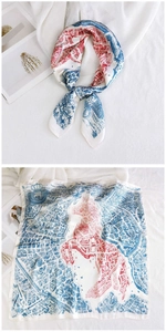 Detailed pattern of a red and blue square silk scarf with map print and horse motif