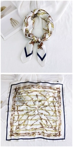 Detailed view of square silk scarf featuring classic chain and belt patterns
