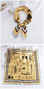 Detail of yellow silk square scarf with equestrian horse motifs and gray border edge