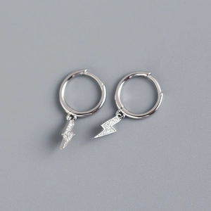 Close-up of S925 sterling silver lightning bolt earrings with shimmering zircon stones