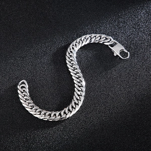 Silver curb chain bracelet for men with square lobster clasp on black background