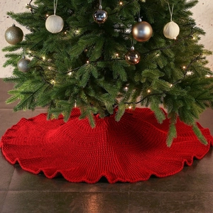 Classic red knitted Christmas tree skirt with festive textures for holiday floor decoration