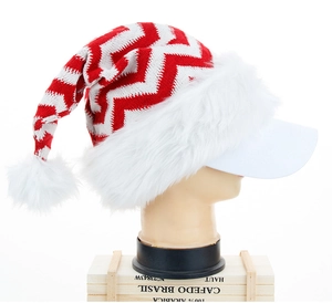 Close-up of red and white striped knitted Christmas hat with white plush pom-pom and trim