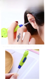 Detail of green frog-shaped earwax tool with LED light showing length and usage