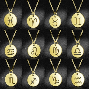 Array of 12 gold circular zodiac pendant necklaces with hollow cutout constellations
