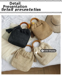 Detail of multi-color woven straw handbags with round wooden handles and tassels