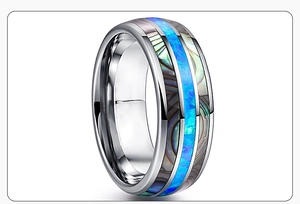 Detailed macro view of silver titanium steel ring with blue opal and abalone shell inlay