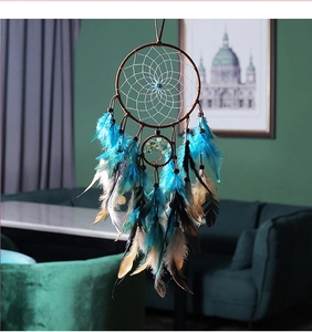 Detail of blue dream catcher with Tree of Life design and feathers for wall hanging