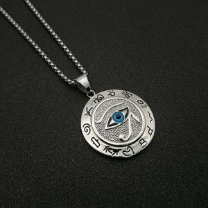 Silver Eye of Horus stainless steel pendant necklace with blue accents on black fabric