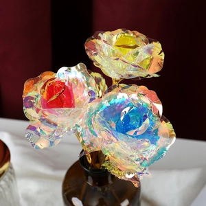 Three 24k gold foil artificial roses in red blue and yellow colors in a glass vase