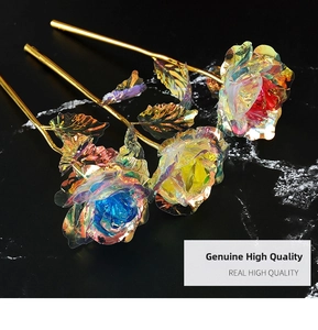 Three 24k gold-plated iridescent roses with vibrant rainbow petals on black marble
