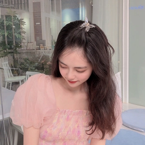 Elegant transparent butterfly hair clip for girls, worn on model in a cozy cafe setting