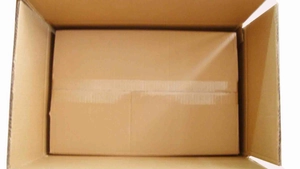 Detailed view of corrugated cardboard outer box with secure inner packaging for card holder