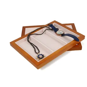 Three-slot wooden jewelry display tray with beige velvet lining for rings and watches