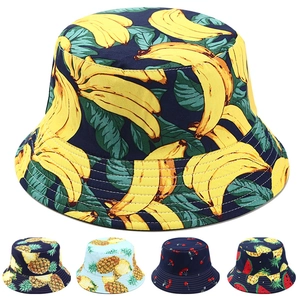 Detail of reversible bucket hat with banana and pineapple fruit print patterns