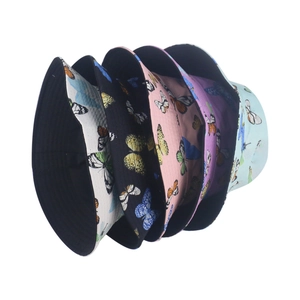 Folded collection of chic cotton bucket hats with colorful butterfly prints in five colors