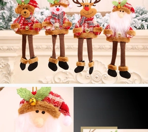 Close-up of four Christmas plush doll ornaments with red plaid and golden bells