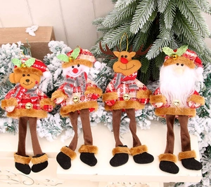 Detail view of plush Christmas ornaments with red plaid outfits and gold bells
