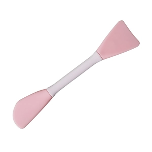 Dual-ended pink and white silicone facial mask brush with spatula and curved applicator