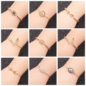 Adjustable gold bracelet set with micro-pave zircons, evil eye and butterfly charms