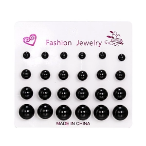 Set of 12 pairs of black pearl stud earrings in various sizes on a white display card