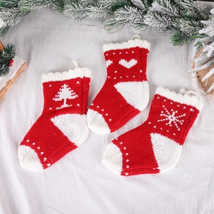 Set of 3 knitted red and white Christmas stockings with snowflake and tree patterns