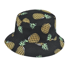 Detail of black canvas bucket hat with yellow pineapple prints for summer outdoor wear