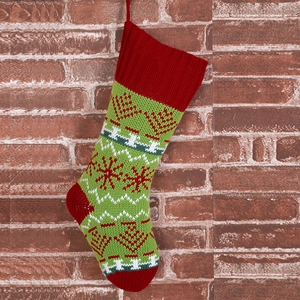 Detailed view of red and white knitted Christmas stockings on a vintage brick wall background