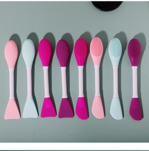 Detail view of double-ended silicone facial mask brushes in multiple pastel colors