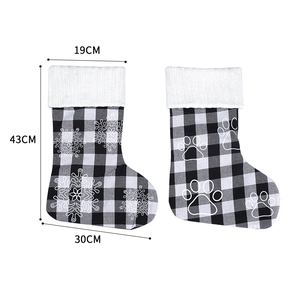 Detail view of 18-inch plaid Christmas stockings with snowflake and paw print size specs