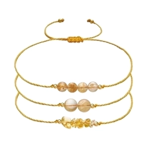 Detail of three handmade braided gold ropes with citrine beads and adjustable pull cords