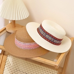 Flat top straw sun hats for men and women with bohemian style woven patterned ribbons