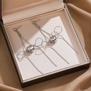 Polished silver heart earrings with snake chain bow and long fringe tassels on satin