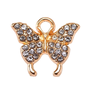 Detailed macro shot of a gold butterfly pendant featuring sparkling clear zircon crystals