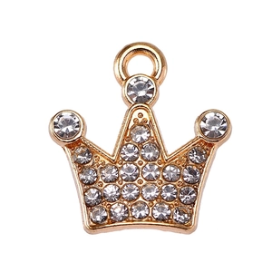 Macro shot of gold crown pendant featuring sparkling rhinestones and a top jump ring