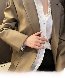 Three stacked minimalist 18K gold plated titanium steel rings worn on female hand