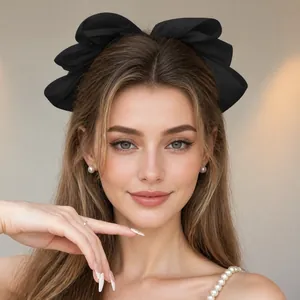 Minimalist large black pearl bow hair clip on a young woman for an elegant hair accessory