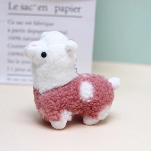 Close-up of a mini pink and white alpaca plush pendant with soft lamb wool texture