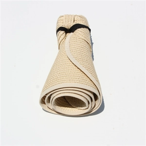 Detail showing the portable roll-up design and fine woven texture of beige straw hat