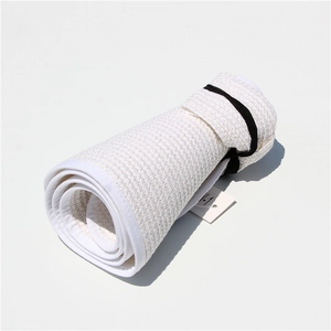 Detail view of foldable straw sun visor showing the portable roll-up design and compact storage