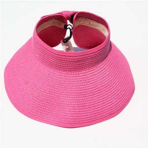 Close-up of rose red straw sun visor showing woven texture and adjustable strap