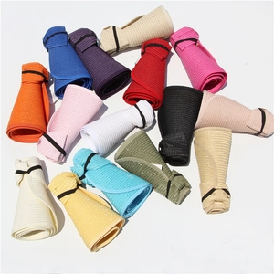 Detailed collection of foldable straw hats in various vibrant colors on a white surface